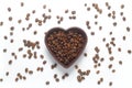 Roasted coffee beans in heart shaped bowl on white background. Royalty Free Stock Photo