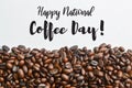 Roasted coffee beans isolated on a white background with text HAPPY NATIONAL COFFEE DAY