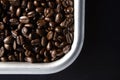 Roasted coffee beans in a metal tray on black background Royalty Free Stock Photo