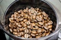 Roasted coffee beans in a millstone coffee grinder