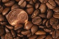 Roasted coffee beans and one five euro cent coin close-up Royalty Free Stock Photo