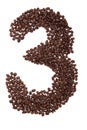 Roasted coffee beans placed in the shape of number three Royalty Free Stock Photo