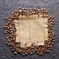 Roasted coffee beans, on sackcloth, closeup image, space for text Royalty Free Stock Photo