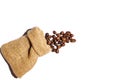 Roasted coffee beans scattered from burlap bag isolated on white background. Copy space Royalty Free Stock Photo