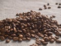 Roasted coffee beans scattered on a burlap napkin Royalty Free Stock Photo