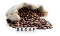 Roasted coffee beans scattered out of the bag. Concept of decaf coffee