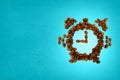 Roasted coffee beans shaped as ringing alarm clock. Royalty Free Stock Photo