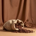 Roasted Coffee Beans Spilling from Burlap Sack on Brown Fabric Background with Soft Lighting Royalty Free Stock Photo