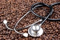 roasted coffee beans and a stethoscope