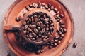 Roasted coffee beans in a vintage ceramic brown cup. Symbolic image. Top view, selective focus Royalty Free Stock Photo