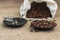 Roasted coffee beans, weighed on an antique hand scale with weights, lying on a table Royalty Free Stock Photo