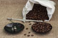 Roasted coffee beans, weighed on an antique hand scale with weights, lying on a table Royalty Free Stock Photo