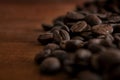 Roasted coffee beans on a wooden background, close up. Copy space. Royalty Free Stock Photo