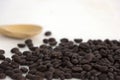 Roasted coffee beans and a wooden spoon on white background Royalty Free Stock Photo