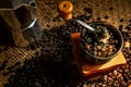 Roasted coffee seed in vintage grinder preparing to boil by espresso coffee pot