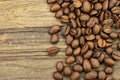 Roasted coffee beans on wood background.