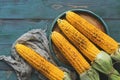 Roasted corn barbecue, green rustic background. View from above, flat lay.