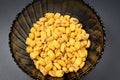 Roasted corn nuts in plate on dark background Royalty Free Stock Photo