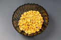 Roasted corn nuts in plate on dark background Royalty Free Stock Photo