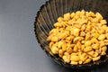 Roasted corn nuts in plate on dark background Royalty Free Stock Photo