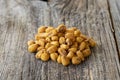 Roasted corn snack. Corn nuts with sauce on wood background