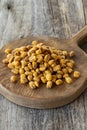 Roasted corn snack. Corn nuts with sauce on wood background Royalty Free Stock Photo