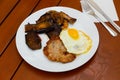 Roasted cutlet with fried egg and frilled vegetables