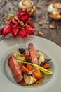 Roasted duck breast with cabbage and pancake served on white plate with glass of wine, winter and seasonal food, product photograp Royalty Free Stock Photo