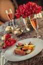 Roasted duck breast with cabbage and pancake served on white plate with glass of wine, winter and seasonal food, product photograp Royalty Free Stock Photo