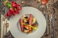 Roasted duck breast with cabbage and pancake served on white plate with glass of wine, winter and seasonal food, product photograp