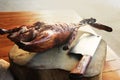 Roasted duck and Chineses knife on tamarind wood cutting board Royalty Free Stock Photo