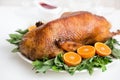 Roasted duck in honey glaze with spicy herbs and tangerines