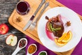 Roasted duck leg on platter with glass of red wine Royalty Free Stock Photo