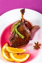 Roasted duck leg on platter with red wine Royalty Free Stock Photo