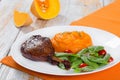 Roasted duck leg on platter with spinach and pumpkin porridge Royalty Free Stock Photo