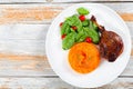 Roasted duck leg on platter with spinach and pumpkin porridge Royalty Free Stock Photo