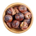 Roasted edible sweet chestnuts in wooden bowl isolated on white background. Top view Royalty Free Stock Photo