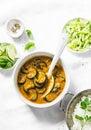 Roasted eggplant curry sauce and rice on a light background, top view. Indian vegetarian cuisine.