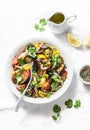 Roasted eggplant, sweet tomato and cilantro mediterranean style salad on light background, top view. Vegetarian food Royalty Free Stock Photo