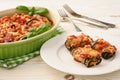 Roasted eggplants stuffed with minced meat and baked with tomatoes and cheese.