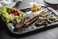 Roasted fish on dish with fresh and grilled vegetable Royalty Free Stock Photo