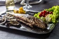 Roasted fish on dish with fresh and grilled vegetable Royalty Free Stock Photo