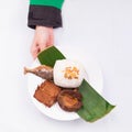 Roasted fish with fried tempeh, petai, cucumber, lettuce, leunca, fried shallot, and white rice with hand Royalty Free Stock Photo