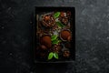 Roasted fragrant coffee beans on a black stone background. Top view. Free space for your text