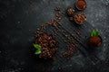 Roasted fragrant coffee beans on a black stone background. Top view.