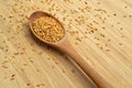 Roasted organic sesame seeds, in wooden spoon on bamboo cutting board Royalty Free Stock Photo