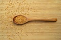 Roasted organic sesame seeds, in wooden spoon on bamboo cutting board Royalty Free Stock Photo