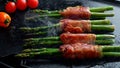 Roasted fried green asparagus with bacon and vegetables on grill Royalty Free Stock Photo