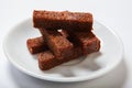 Roasted garlic croutons, black bread on a white plate. Royalty Free Stock Photo