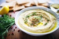 roasted garlic hummus with cloves around the bowl edge Royalty Free Stock Photo